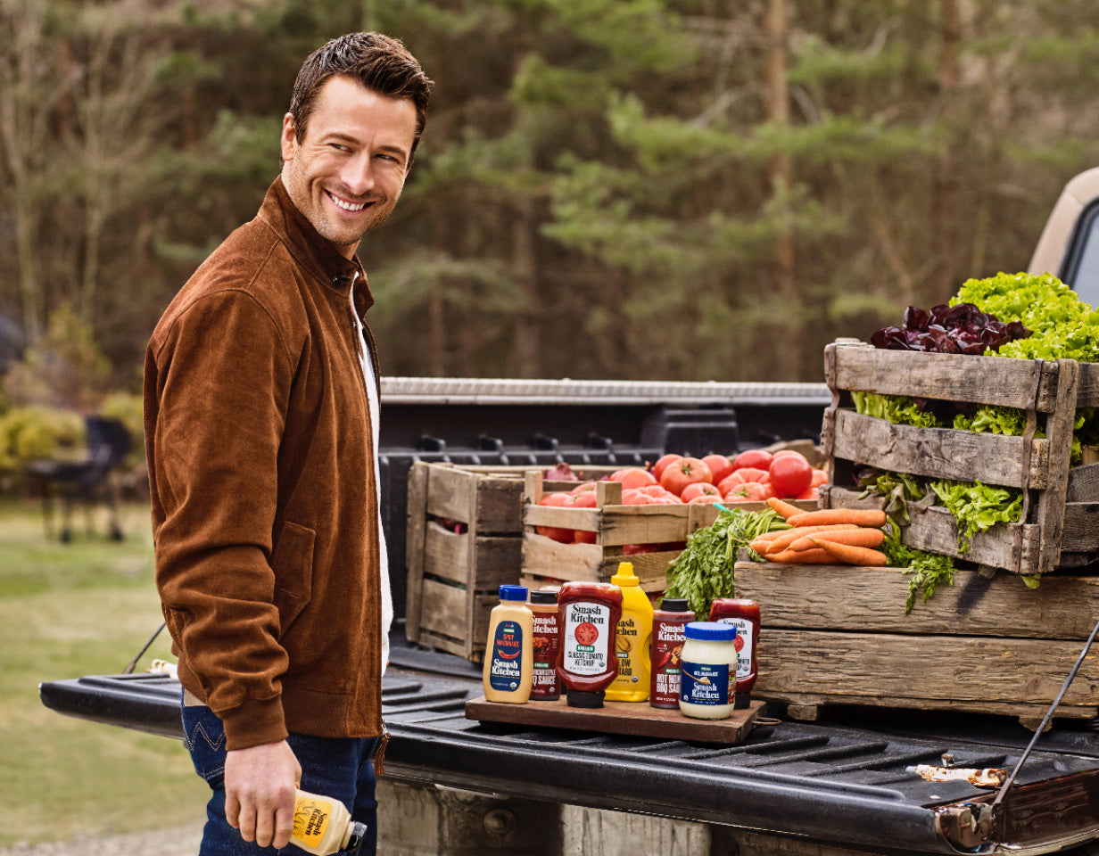 Smash Kitchen co-founder Glen Powell with Smash Kitchen products and produce in the back of a truck.