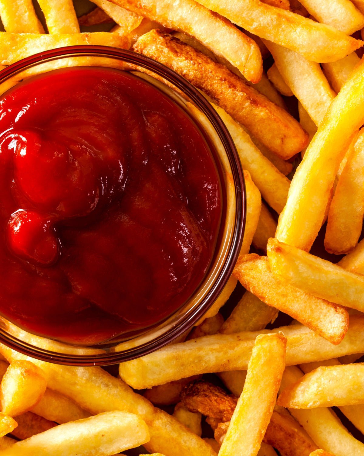 French fries and a small container of Smash Kitchen Hot Honey Ketchup